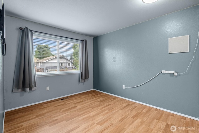 742 N 103rd St, Seattle, WA 98133 - empty room featuring wood finished floors and baseboards