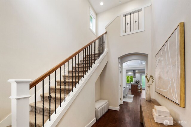 17477 NE 123rd Way, Redmond, WA 98052 - stairs with arched walkways, hardwood / wood-style flooring, a towering ceiling, and recessed lighting