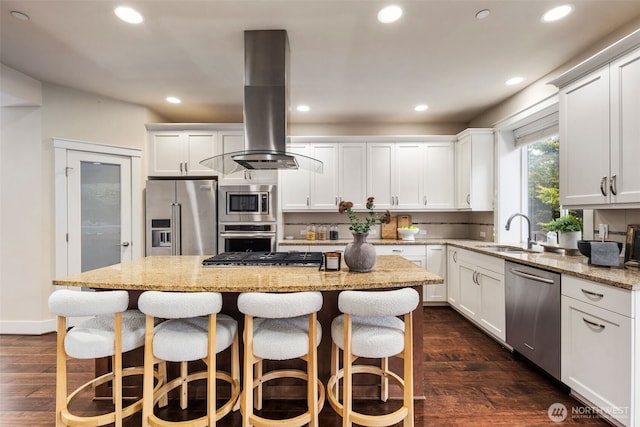 17477 NE 123rd Way, Redmond, WA 98052 - kitchen featuring appliances with stainless steel finishes, island range hood, a center island, dark wood-style flooring, and recessed lighting