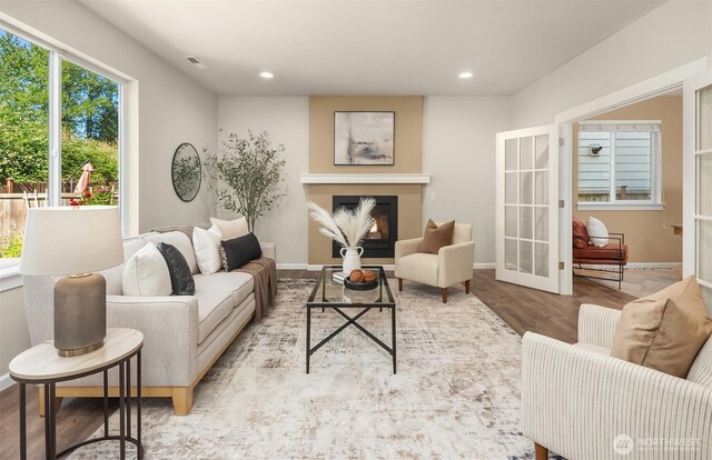 12611 37th Pl NE, Lake Stevens, WA 98258 - living room with wood finished floors, recessed lighting, a glass covered fireplace, and french doors