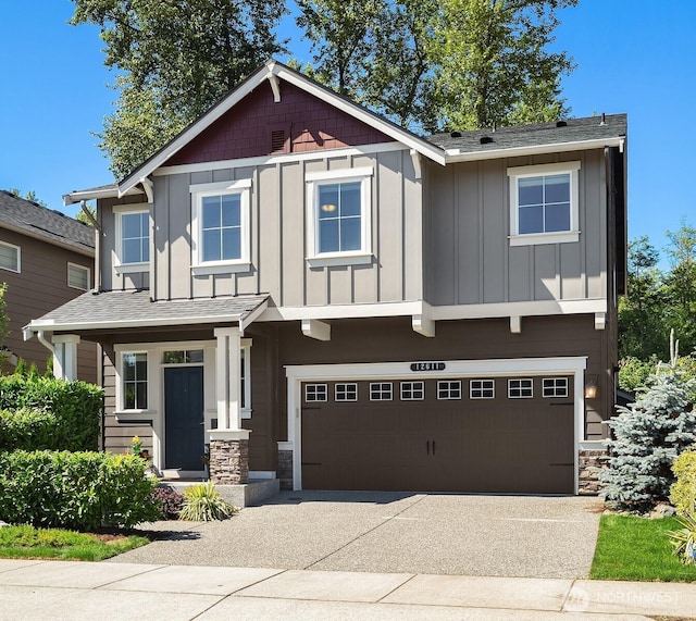 12611 37th Pl NE, Lake Stevens, WA 98258 - craftsman-style house with board and batten siding, stone siding, concrete driveway, an attached garage, and a shingled roof