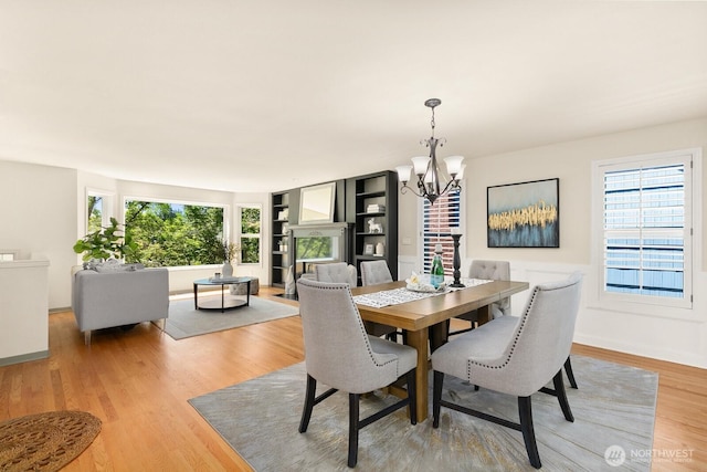 2218 N 38th St, Seattle, WA 98103 - dining area with a chandelier and light wood finished floors