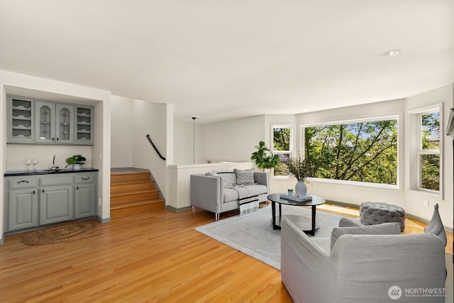 2218 N 38th St, Seattle, WA 98103 - living room with light wood-type flooring, plenty of natural light, and bar with sink