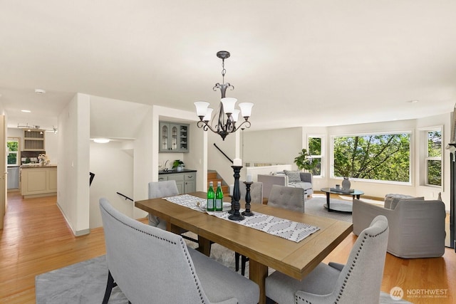 2218 N 38th St, Seattle, WA 98103 - dining area with light wood finished floors and a chandelier