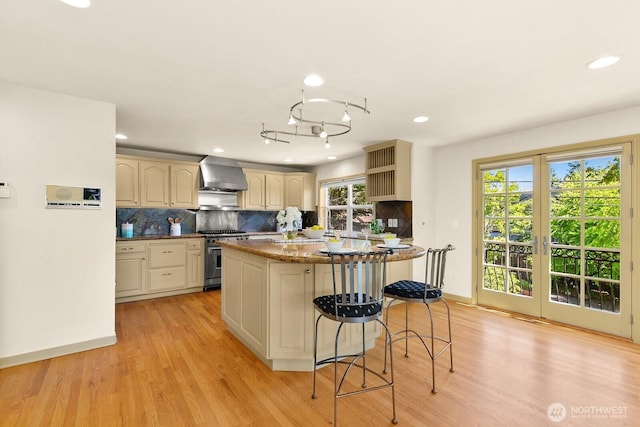2218 N 38th St, Seattle, WA 98103 - kitchen featuring wall chimney range hood, high end range, open shelves, backsplash, and recessed lighting