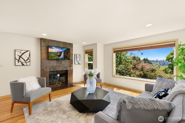 2218 N 38th St, Seattle, WA 98103 - living area with light wood-style floors, a tiled fireplace, and recessed lighting