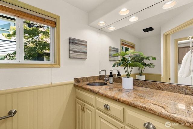 2218 N 38th St, Seattle, WA 98103 - bathroom featuring vanity, a wainscoted wall, and recessed lighting