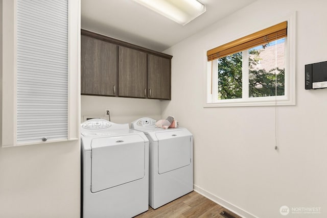 2218 N 38th St, Seattle, WA 98103 - laundry area with cabinet space, washer and dryer, and light wood finished floors