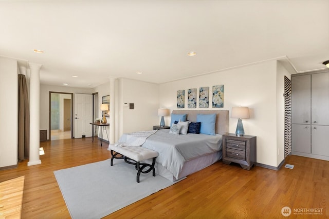 2218 N 38th St, Seattle, WA 98103 - bedroom featuring light wood-type flooring, decorative columns, recessed lighting, and a closet