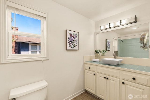 2218 N 38th St, Seattle, WA 98103 - full bathroom with vanity, a shower, and wood finished floors