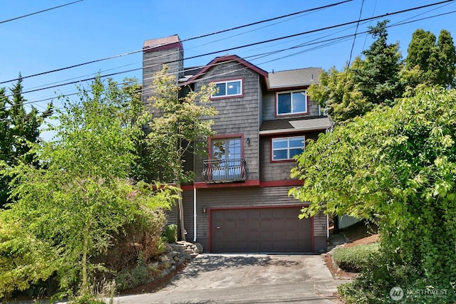 2218 N 38th St, Seattle, WA 98103 - view of front facade featuring driveway, a chimney, a balcony, and a garage