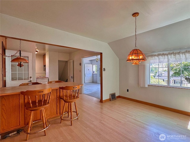 304 Columbia Ave, Coulee Dam, WA 99116 - kitchen with healthy amount of natural light, light wood-style flooring, a chandelier, pendant lighting, and lofted ceiling