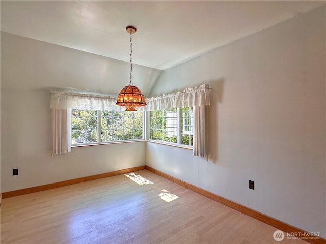 304 Columbia Ave, Coulee Dam, WA 99116 - spare room featuring wood finished floors, lofted ceiling, and a chandelier