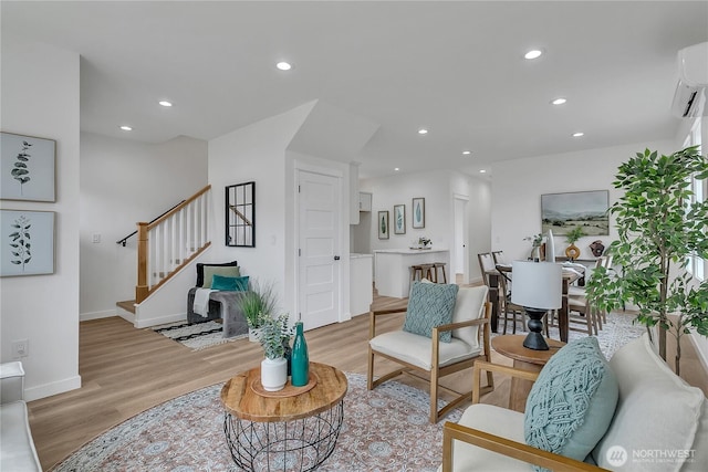 1215 N 10th St, Tacoma, WA 98403 - living room with light wood-style flooring, stairway, recessed lighting, and a wall unit AC