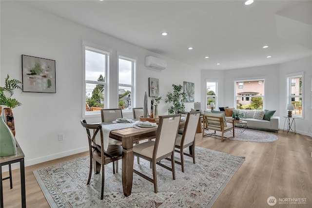 1215 N 10th St, Tacoma, WA 98403 - dining space featuring recessed lighting, healthy amount of natural light, a wall unit AC, and light wood finished floors