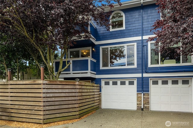 2344 44th Ave SW Unit B, Seattle, WA 98116 - rear view of property featuring an attached garage, a balcony, and driveway