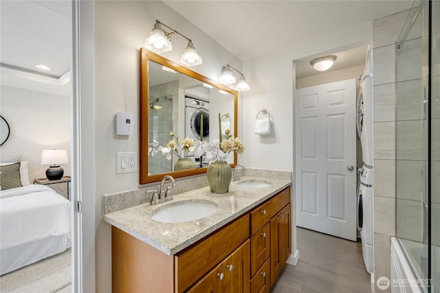 2344 44th Ave SW Unit B, Seattle, WA 98116 - bathroom featuring stacked washer / dryer, double vanity, ensuite bath, and tile patterned floors
