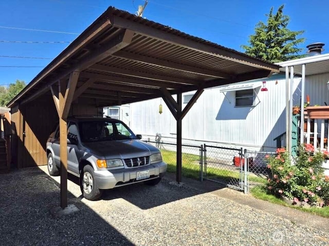 5626 SW 113th Ave E Unit 63, Puyallup, WA 98372 - view of parking / parking lot with a carport and a gate