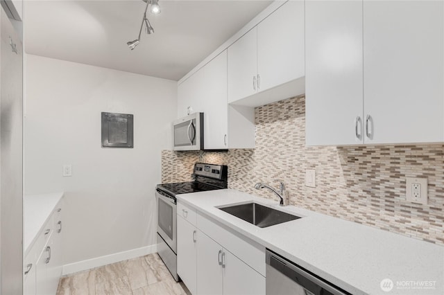 5101 NE 55th St Unit 103, Seattle, WA 98105 - kitchen with stainless steel appliances, light countertops, and white cabinetry