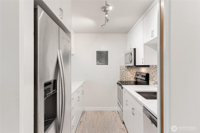 5101 NE 55th St Unit 103, Seattle, WA 98105 - kitchen with appliances with stainless steel finishes, light marble finish flooring, light countertops, and tasteful backsplash
