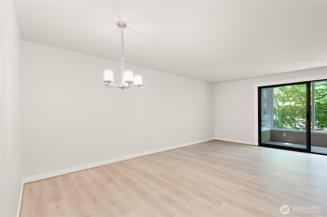 5101 NE 55th St Unit 103, Seattle, WA 98105 - spare room featuring light wood-style floors and a chandelier