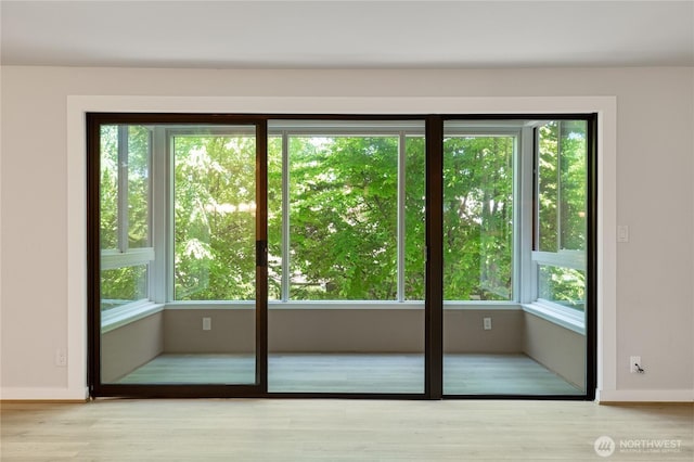5101 NE 55th St Unit 103, Seattle, WA 98105 - doorway to outside featuring wood finished floors and baseboards