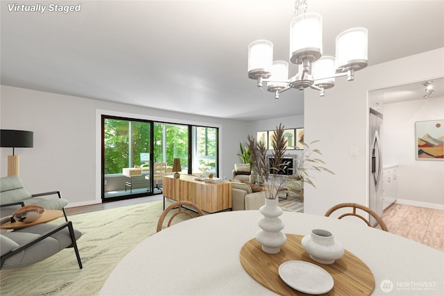 5101 NE 55th St Unit 103, Seattle, WA 98105 - dining area featuring a chandelier and baseboards