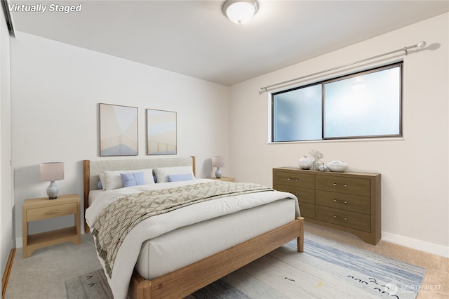 5101 NE 55th St Unit 103, Seattle, WA 98105 - bedroom with baseboards and light colored carpet