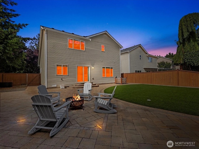 11040 22nd Pl NE, Lake Stevens, WA 98258 - back of house at dusk with a fire pit, a patio area, and a fenced backyard