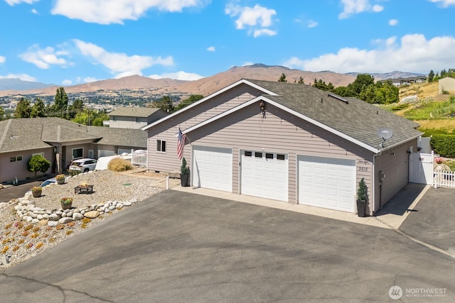 2615 N Baker Ave, East Wenatchee, WA 98802 - view of front of home with a mountain view, asphalt driveway, and a garage