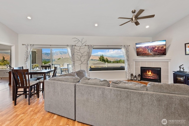 2615 N Baker Ave, East Wenatchee, WA 98802 - living area with a tiled fireplace, ceiling fan, light wood-style floors, recessed lighting, and lofted ceiling