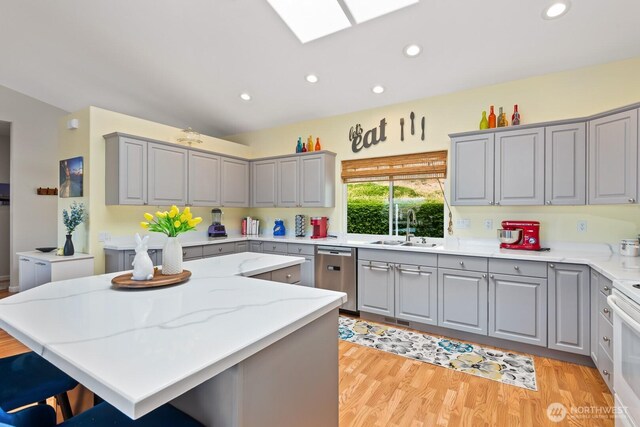 2615 N Baker Ave, East Wenatchee, WA 98802 - kitchen with gray cabinets, dishwasher, a kitchen island, recessed lighting, and a skylight