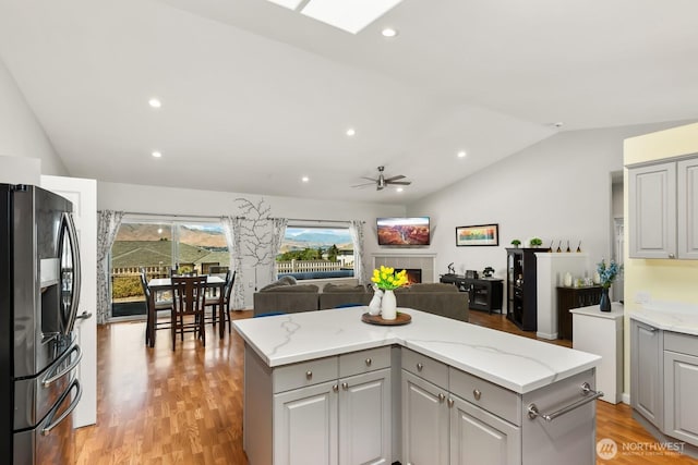 2615 N Baker Ave, East Wenatchee, WA 98802 - kitchen with gray cabinets, stainless steel fridge with ice dispenser, lofted ceiling, a ceiling fan, and a center island