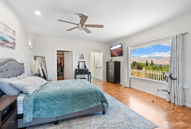 2615 N Baker Ave, East Wenatchee, WA 98802 - bedroom featuring wood finished floors, a spacious closet, connected bathroom, and ceiling fan