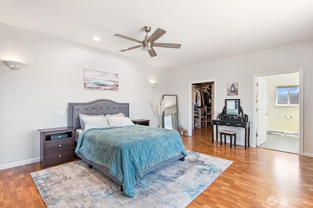 2615 N Baker Ave, East Wenatchee, WA 98802 - bedroom with a walk in closet, wood finished floors, ensuite bath, a ceiling fan, and recessed lighting