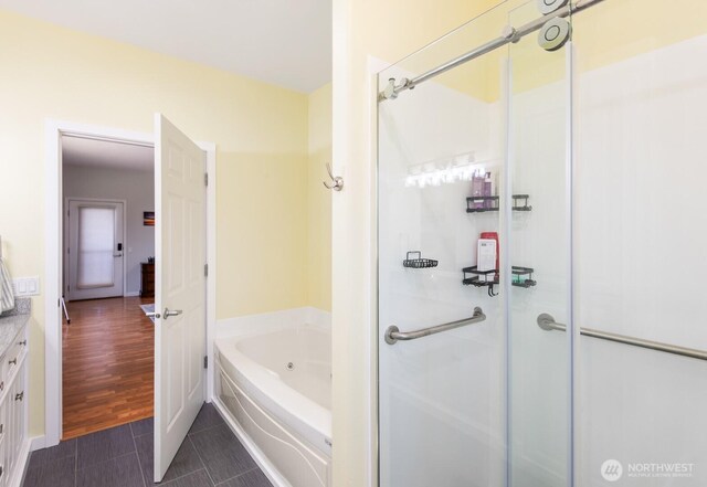 2615 N Baker Ave, East Wenatchee, WA 98802 - full bathroom featuring a shower stall, tile patterned flooring, a jetted tub, and vanity