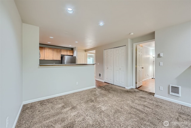 26339 116th Ave SE Unit I202, Kent, WA 98030 - unfurnished living room with carpet floors and recessed lighting
