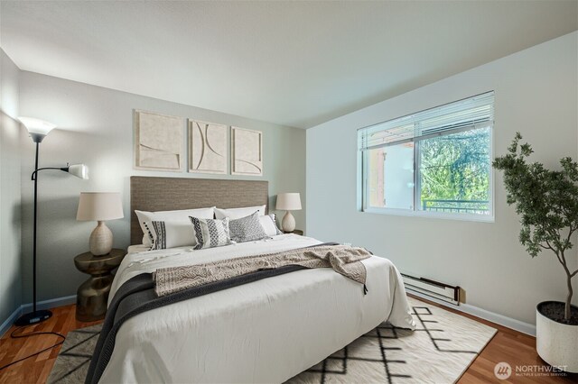 26339 116th Ave SE Unit I202, Kent, WA 98030 - bedroom featuring a baseboard radiator and wood finished floors
