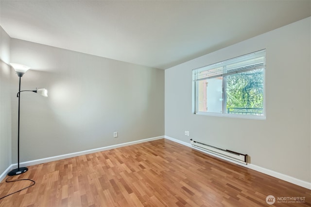 26339 116th Ave SE Unit I202, Kent, WA 98030 - unfurnished room featuring baseboard heating and light wood-style floors