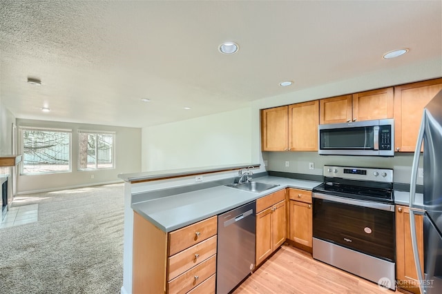 26339 116th Ave SE Unit I202, Kent, WA 98030 - kitchen featuring appliances with stainless steel finishes, a peninsula, recessed lighting, open floor plan, and light countertops