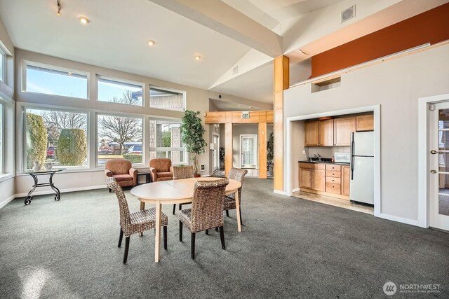 26339 116th Ave SE Unit I202, Kent, WA 98030 - dining space featuring dark colored carpet, a high ceiling, and recessed lighting