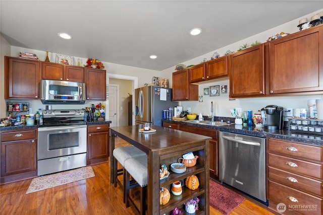 20304 48th Ave E, Spanaway, WA 98387 - kitchen featuring appliances with stainless steel finishes, light wood-style flooring, recessed lighting, open shelves, and brown cabinetry