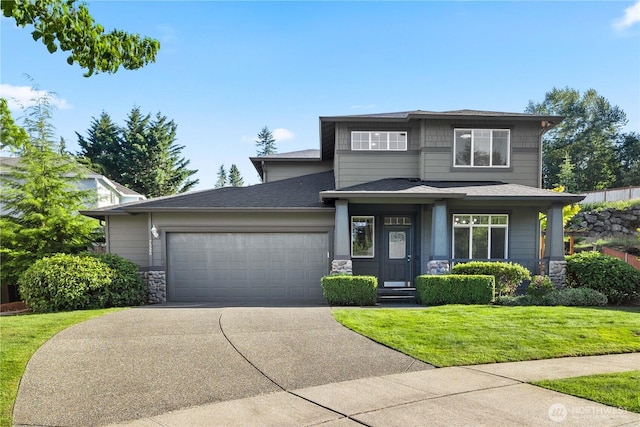 7526 148th Pl SE, Snohomish, WA 98296 - prairie-style house with stone siding, an attached garage, concrete driveway, a front lawn, and roof with shingles