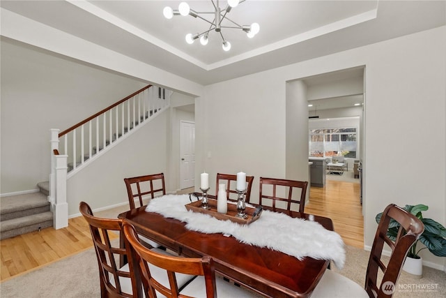 7526 148th Pl SE, Snohomish, WA 98296 - dining space with stairway, light wood-style floors, a chandelier, and a tray ceiling