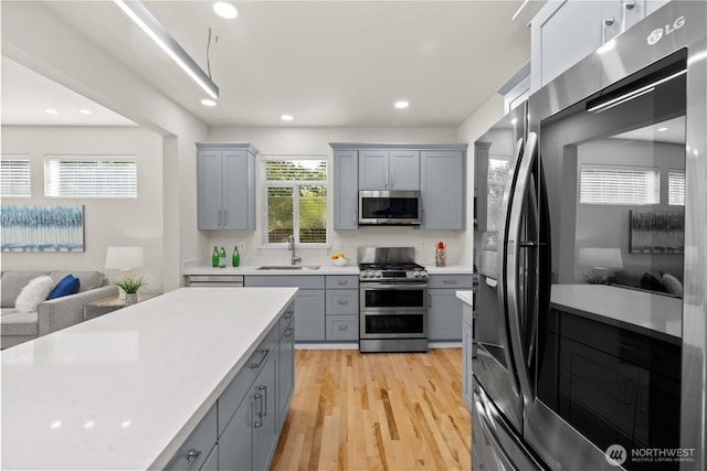 7526 148th Pl SE, Snohomish, WA 98296 - kitchen with appliances with stainless steel finishes, gray cabinets, light wood-type flooring, light countertops, and recessed lighting