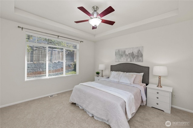 7526 148th Pl SE, Snohomish, WA 98296 - bedroom with a raised ceiling, light colored carpet, and ceiling fan