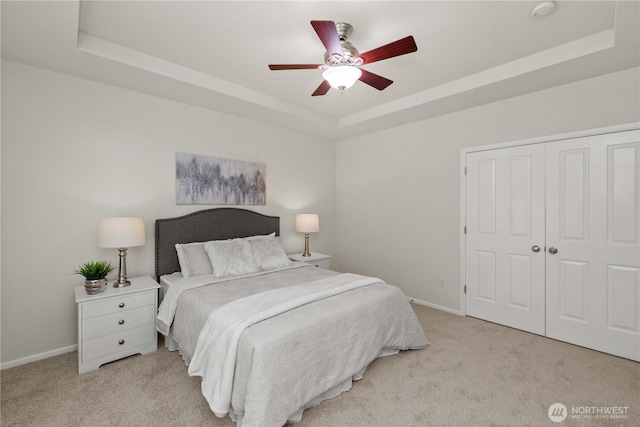 7526 148th Pl SE, Snohomish, WA 98296 - bedroom with a raised ceiling, light carpet, a closet, and ceiling fan