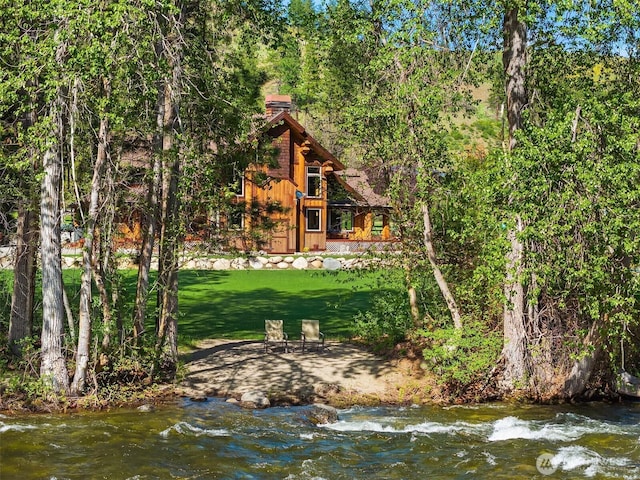 639 A Twisp River Rd, Twisp, WA 98856 - rear view of house with a chimney, a lawn, and a wooded view