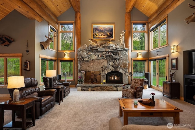 639 A Twisp River Rd, Twisp, WA 98856 - carpeted living room featuring a wooden ceiling with exposed beams, high vaulted ceiling, plenty of natural light, and a stone fireplace