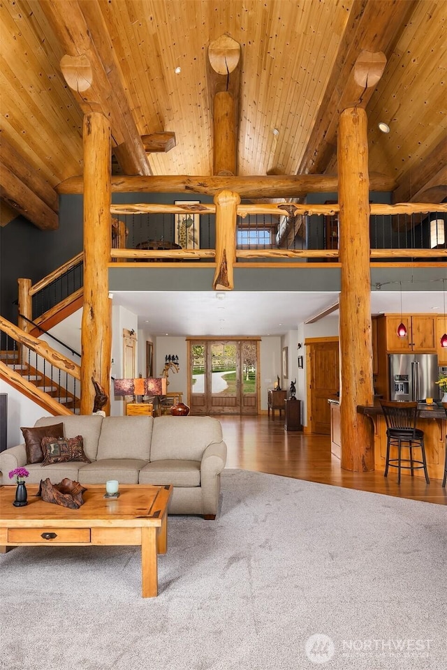 639 A Twisp River Rd, Twisp, WA 98856 - living area featuring a towering ceiling, carpet flooring, wooden ceiling, stairway, and wood finished floors